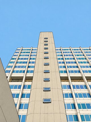 The same tower drawn in clean ink lines and filled in pale grey and blue, the sky one flat blue.